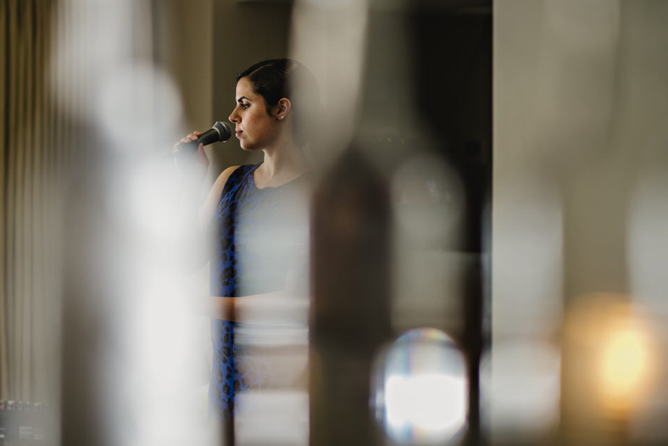 guide to booking music for your wedding - A singer performing at a wedding